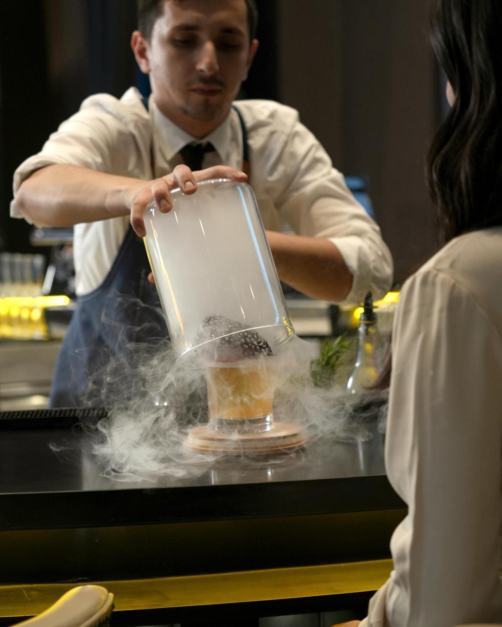 Fairmont Riyadh Exteriör bild A bartender preparing a cocktail with liquid nitrogen