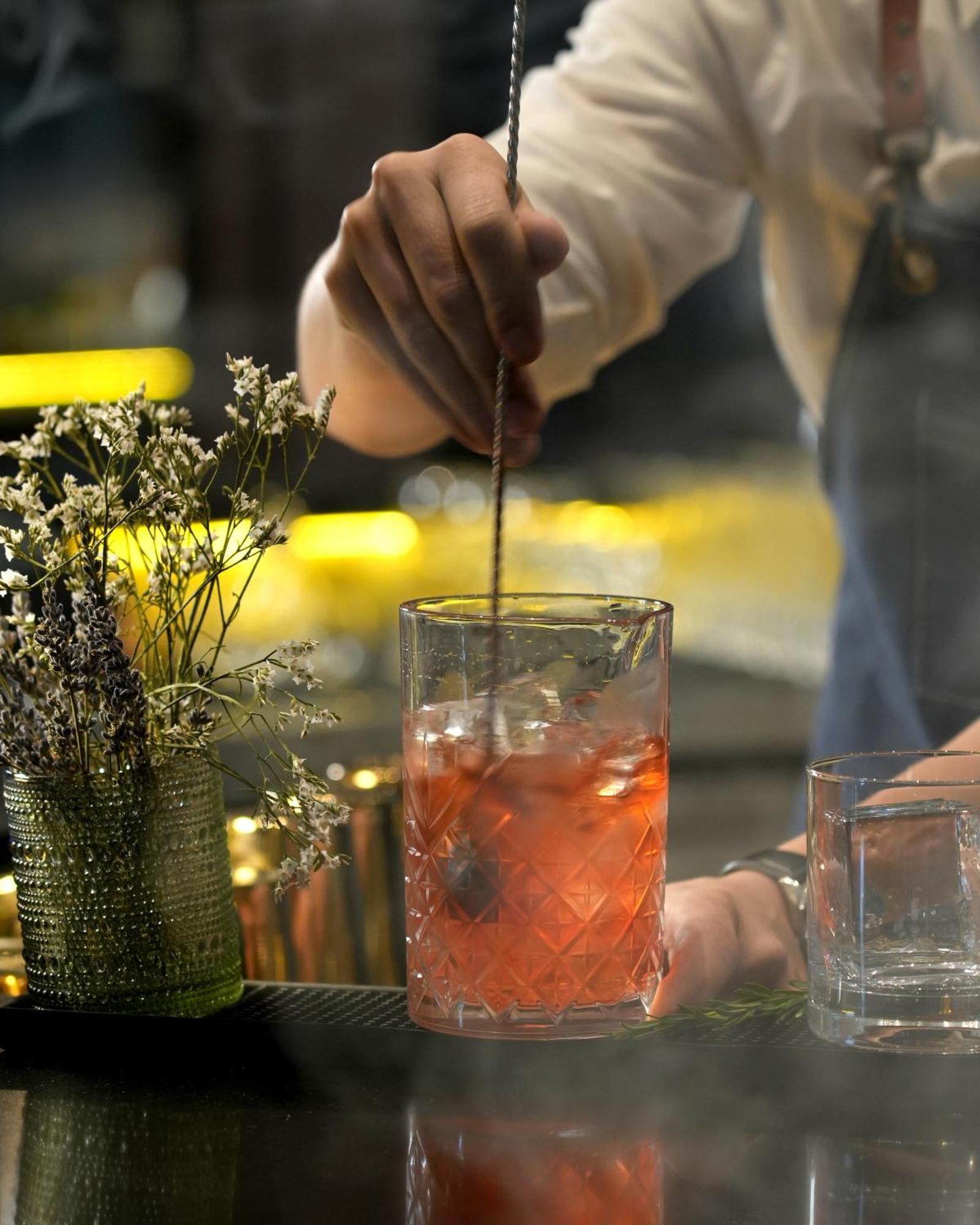 Fairmont Riyadh Exteriör bild A bartender stirring a cocktail